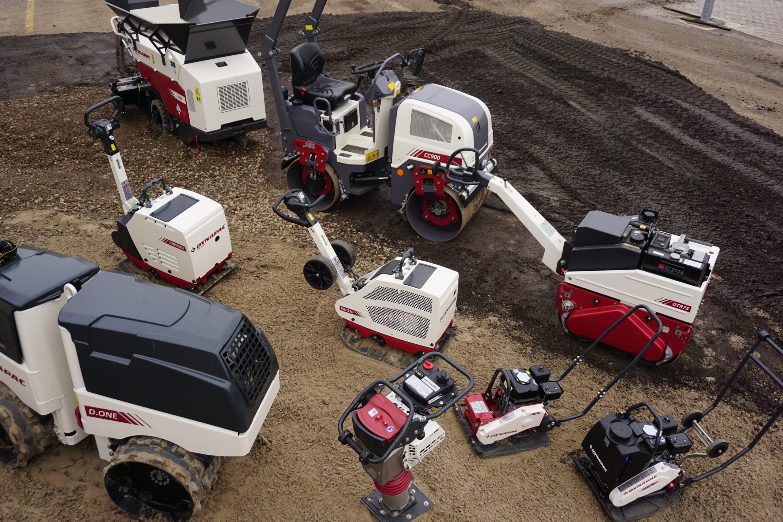 Multiple Dynapac light equipment on a paved dirt track
